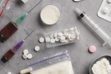 What Is the Difference Between "Production of a Controlled Drug" and "Being Concerned in the Production of a Controlled Drug"?