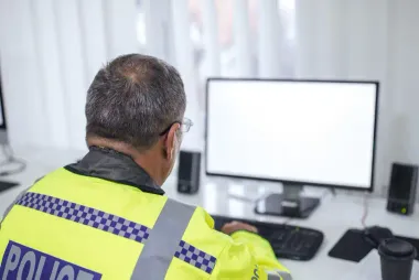 Police officer at computer